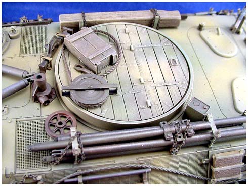 [Building the conversion starts with the deletion of the entire turret assembly and replacing it with a 2 piece resin casting that represents the bolted steel straps and wood decking that was used to blank out the entire turret ring area.]