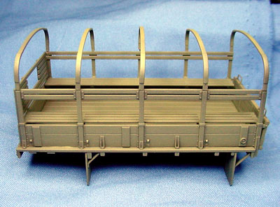 [The Tamiya bed, shown in base coat, is the wooden type and is very pretty, with much crisper detail than the Heller assembly.]