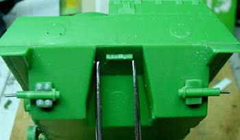 [The idler mounts with and without Grandt Line bolts. Note the pins to mount the idler wheels.]
