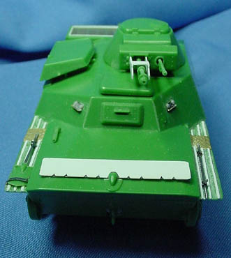 [The view ports on the turret and the sides of the super-structure were replaced with parts made from an empty Eduard fret. The pry bar was replaced with a piece made from metal rod, and the shovel blade was thinned and the molded on mounting bracket was removed, and the handle was cut off and also replaced with metal rod.]