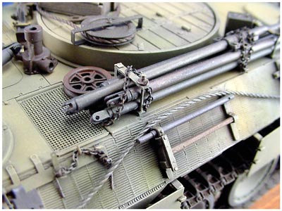 [The passenger side of the turret rind feature an added pair of scratch built brackets, which were used to stow the engine deck crane assembly poles, push beam, and a variety of scratch built rods and beams often seen in period photos.]