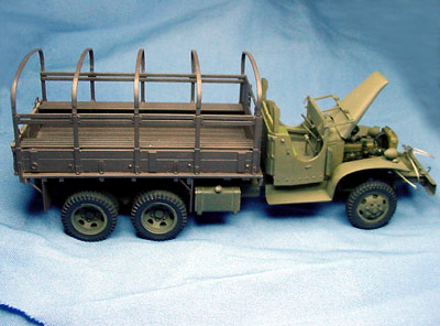 [With just a little effort, I was able to mate the Tamiya bed, shown in primer, to the Heller chassis.]